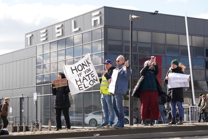 A protest outside of a Tesla center in London.