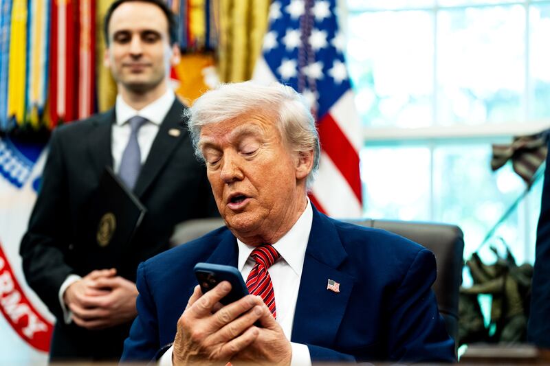 President Donald Trump, pictured silencing his cellphone in the Oval Office on May 23, has long been known for picking up the phone and making calls to reporters to get his side of a story out.