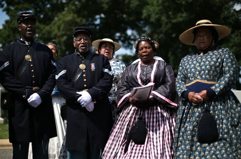 ARLINGTON, VA - JUNE 05: Period Re-enactors attend an event at the gravesite of Buffalo Soldier Col. Charles Young, at Arlington Cemetery, June 5, 2013 in Arlington, Virginia.