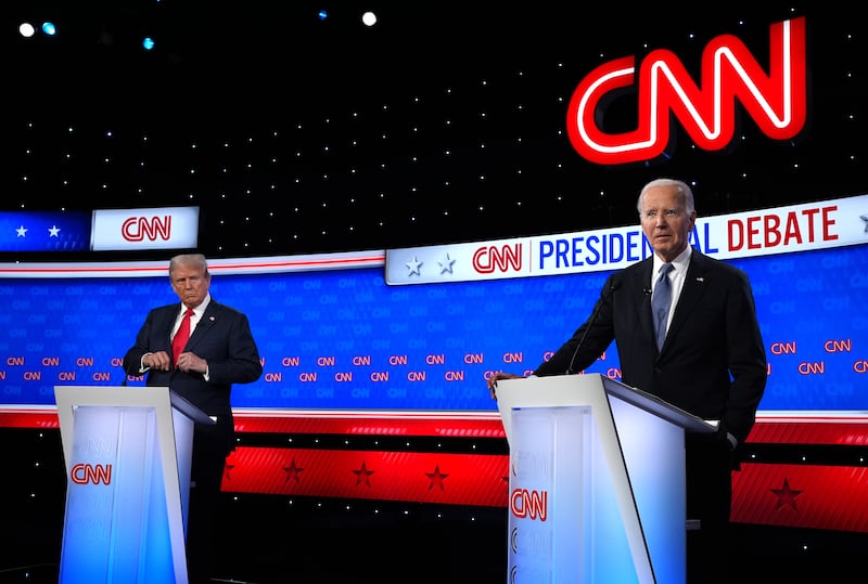 Donald Trump (L) looks at Joe Biden during the CNN Presidential Debate at the CNN Studios on June 27, 2024 in Atlanta, Georgia.