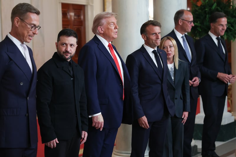 (L-R) Finnish President Alexander Stubb, Ukrainian President Volodymyr Zelensky, U.S. President Donald Trump, French President Emmanuel Macron, Italian Prime Minister Giorgia Meloni, German Chancellor Friedrich Merz, and NATO Secretary General Mark Rutte prepare to depart after a group photo prior to meeting at the White House on August 18, 2025 in Washington, DC.
