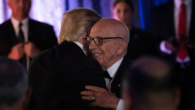 Trump and Murdoch embrace at a 2017 dinner commemorating the 75th anniversary of the Battle of the Coral Sea during WWII.