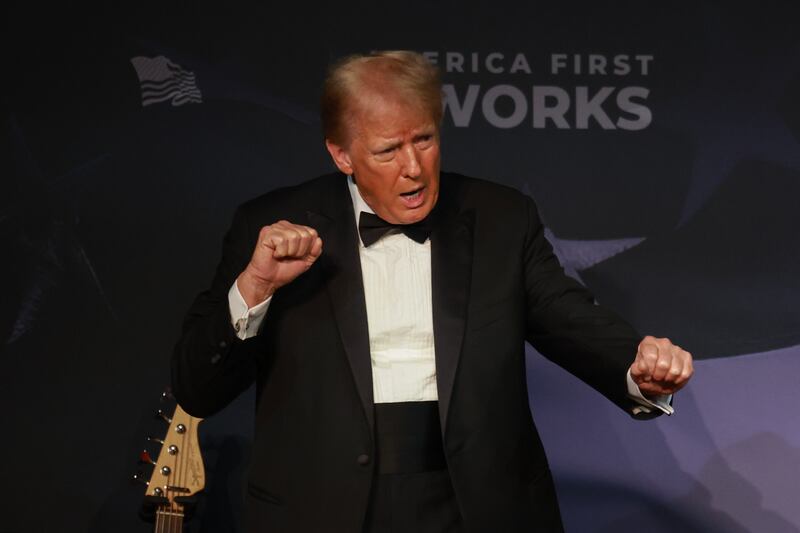 Donald Trump gestures while wearing a tuxedo at an America First Policy Institute Gala held at Mar-a-Lago.