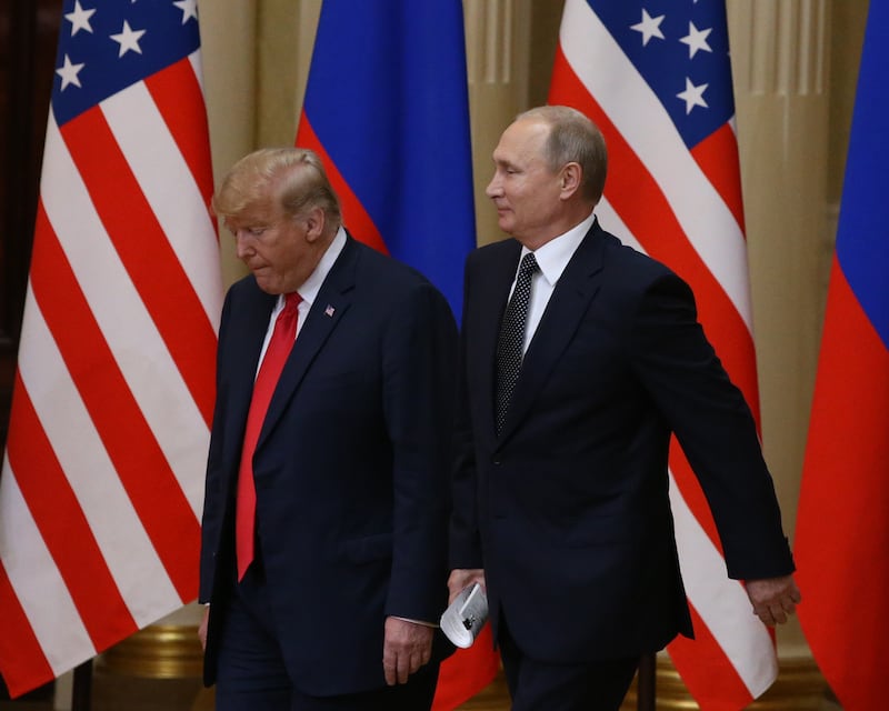 President Donald Trump (L) and Russian President Vladimir Putin arrive for a joint press conference after their summit on July 16, 2018 in Helsinki, Finland.