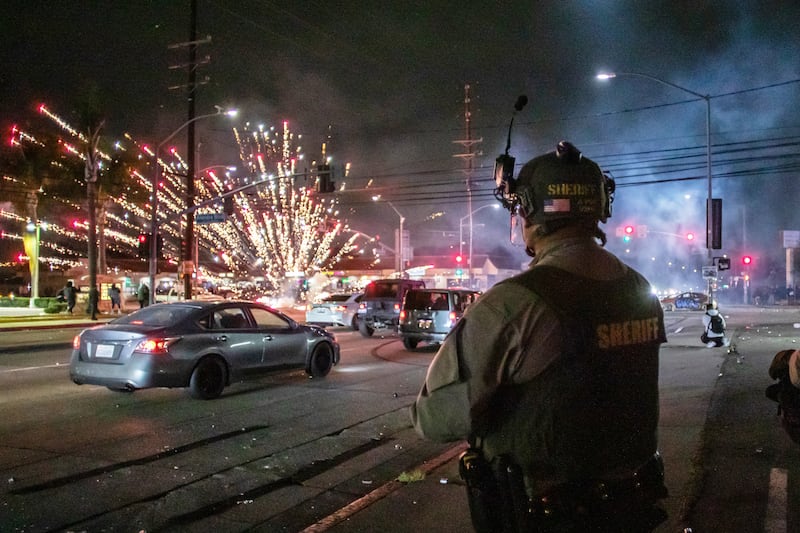 A firework sent by protesters explodes near by the Los Angeles Sheriff Department officers during immigration protest on June 7, 2025 in Paramount, California.