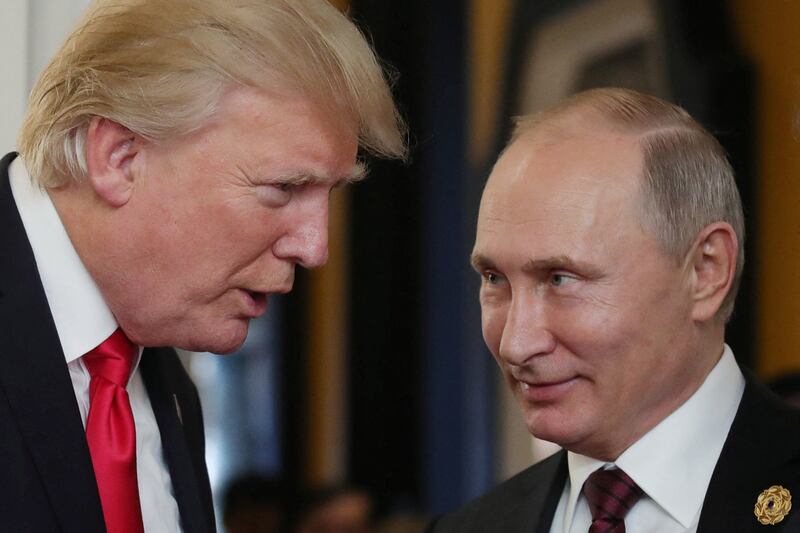US President Donald Trump (L) chats with Russia's President Vladimir Putin as they attend the APEC Economic Leaders' Meeting, part of the Asia-Pacific Economic Cooperation (APEC) leaders' summit in the central Vietnamese city of Danang on November 11, 2017.