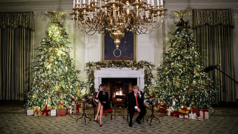 President Donald Trump and first lady Melania Trump speak on the phone with children as they track Santa Claus with the North American Aerospace Defense Command, NORAD.