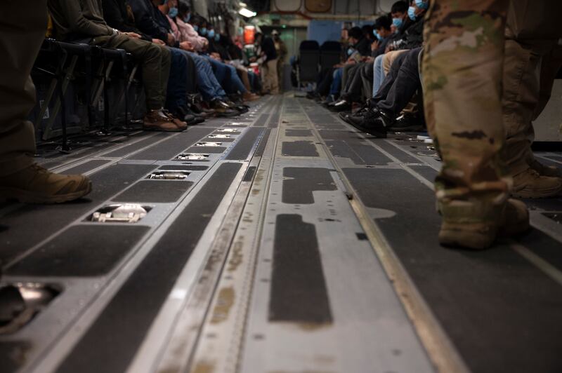 In this handout provided by the U.S. Department of Defense, immigrants await takeoff in a military plane for a removal flight at the Tucson International Airport, on January 23, 2025 in Tucson, Arizona.