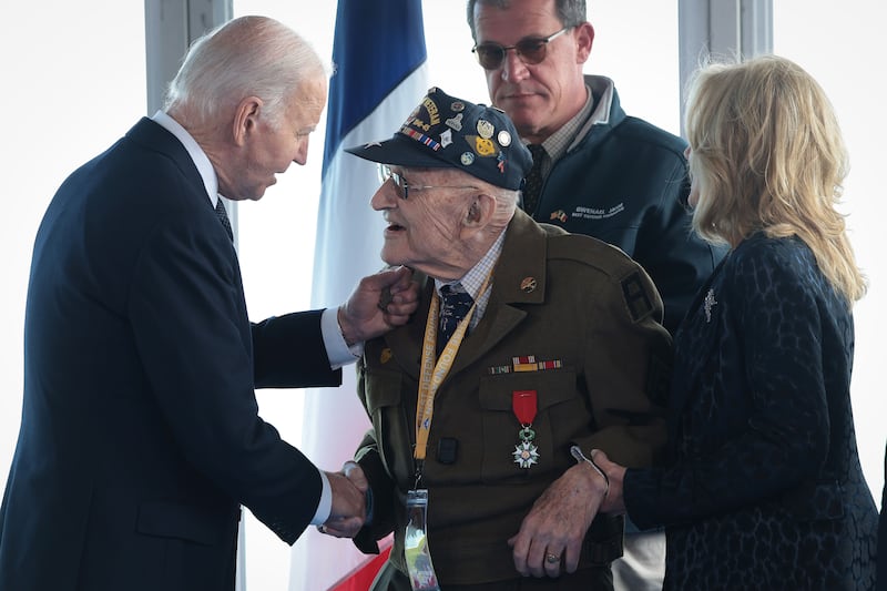 Joe Biden greets a WWII veteran at a ceremony in Normandy.