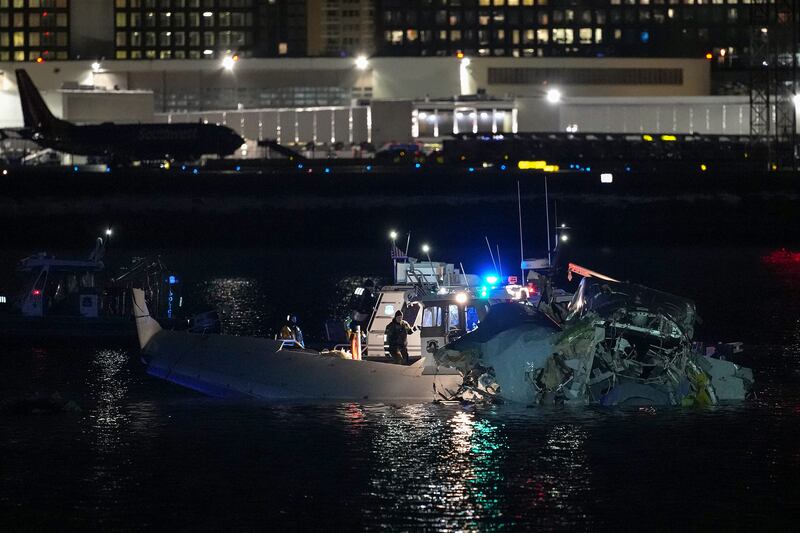 Emergency response units assess airplane wreckage in the Potomac River near Ronald Reagan Washington Airport on January 30, 2025 in Arlington, Virginia.