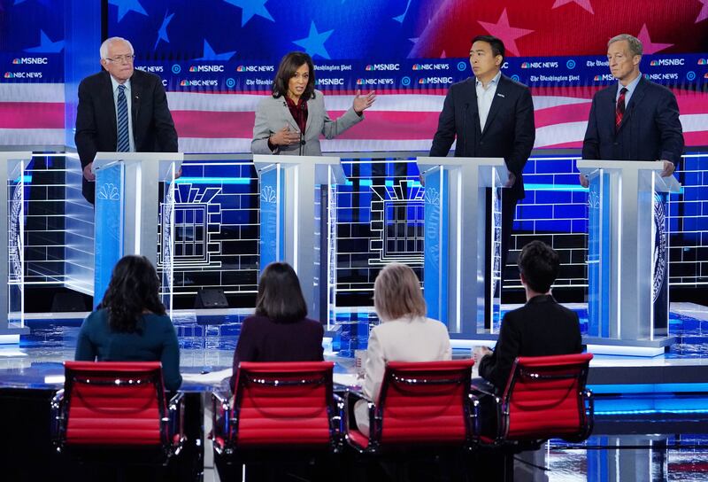 Democratic U.S. presidential candidates Senator Bernie Sanders, entrepreneur Andrew Yang and billionaire activist Tom Steyer listen as Senator Kamala Harris speaks during the fifth 2020 campaign debate, November 20, 2019.