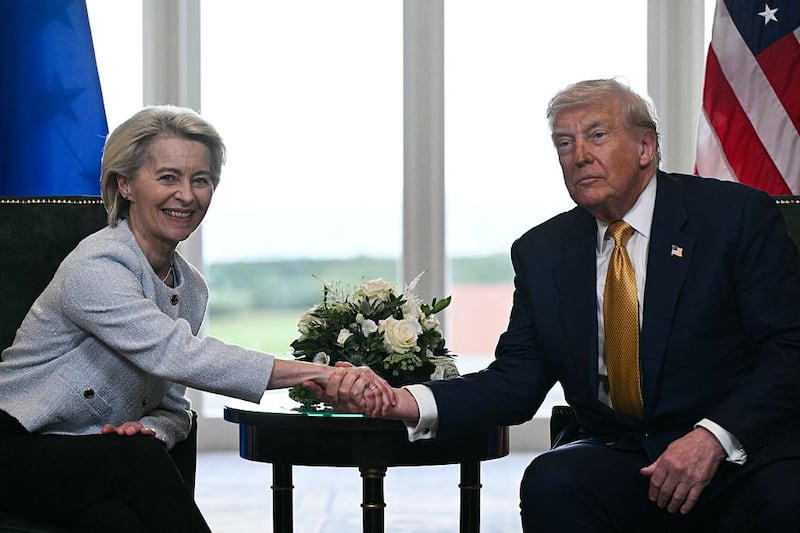 TOPSHOT - US President Donald Trump (R) shakes hands with European Commission President Ursula von der Leyen (L) after agreeing on a trade deal between the two economies following their meeting, in Turnberry south west Scotland on July 27, 2025, on the third day of his visit to the country, since his second tenure as President began. US President Donald Trump said on July 27, 2025 that he had reached a trade agreement with European Union chief Ursula von der Leyen. "We have reached a deal. It's a good deal for everybody," Trump told reporters after talks with von der Leyen at his golf resort in Turnberry, Scotland. The EU chief also hailed it as a "good deal". (Photo by Brendan SMIALOWSKI / AFP) (Photo by BRENDAN SMIALOWSKI/AFP via Getty Images)