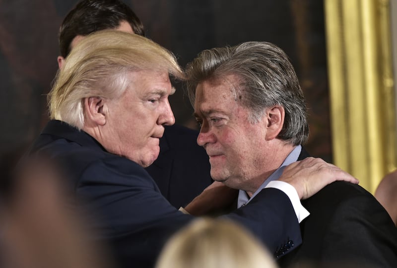US President Donald Trump (L) congratulates Stephen Bannon.