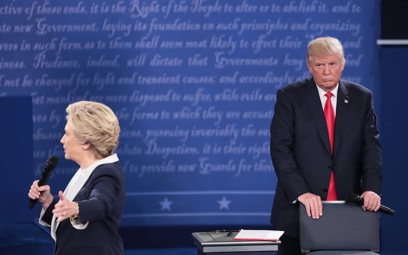 Hillary Clinton (L) and Donald Trump during the town hall debate at Washington University on October 9, 2016 in St Louis, Missouri.