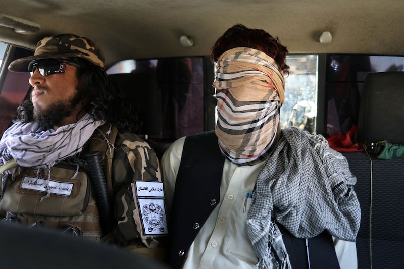 A suspected ISIS member sits blindfolded in a Taliban Special Forces' car in Kabul, Afghanistan, September 5, 2021.