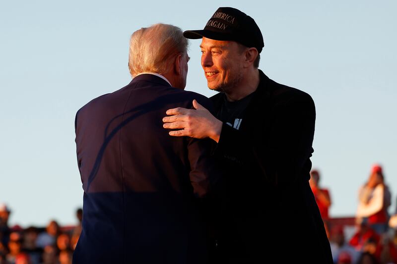 Elon Musk embraces Donald Trump during a campaign rally on October 05, 2024 in Butler, Pennsylvania.