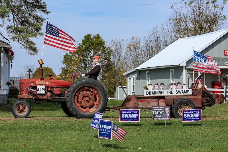 A picture of a rural home with American flags and pro Donald Trump memorabilia