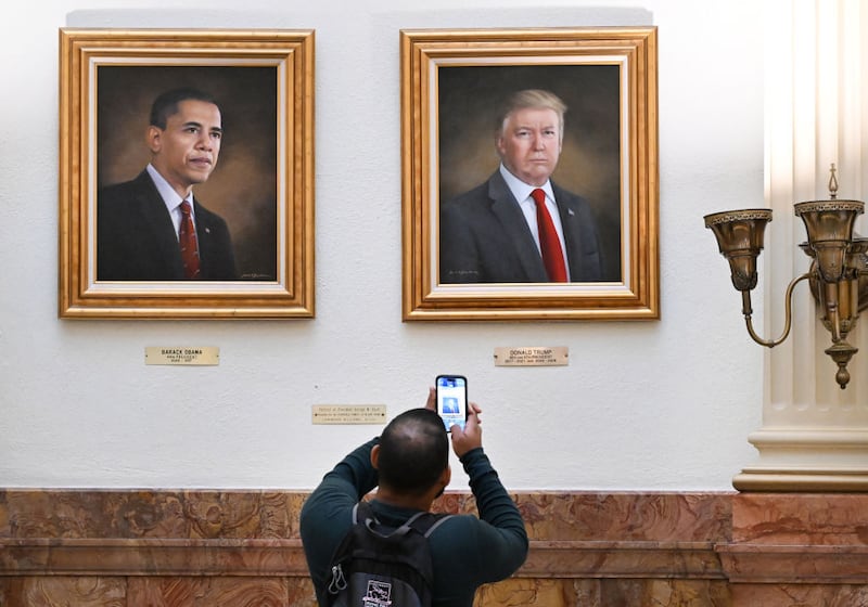 DENVER, CO - MARCH 24: A visitor takes a picture of the portrait of president Donald Trump, right, that hang on walls in the rotunda on the third floor of the Colorado State Capitol in Denver, Colorado on March 24, 2025. The portraits of Presidents Barack Obama, left, and Donald Trump were painted by Sarah A. Boardman. Boardman painted Trump's portrait in 2019. (Photo by Helen H. Richardson/MediaNews Group/The Denver Post via Getty Images)