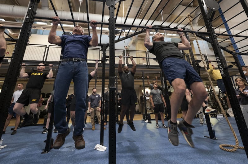 Robert F. Kennedy, left, and Pete Hegseth, right, completed a challenge at the Pentagon on Monday that required them to complete 50 pullups and 100 pushups in 10 minutes or less.