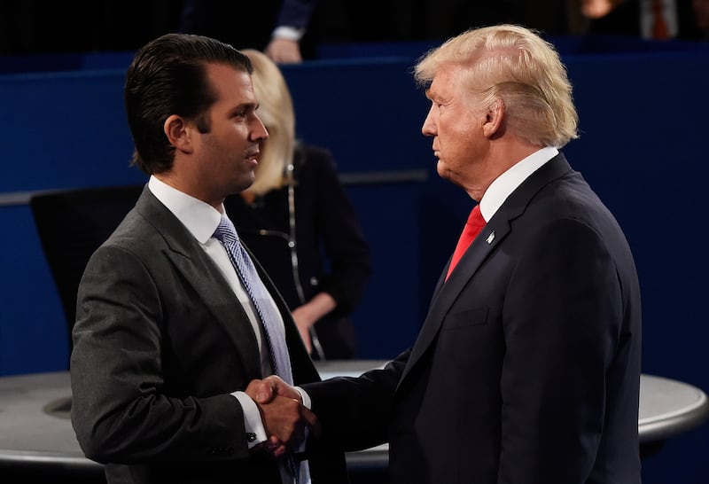 Donald Trump, Jr. (L) greets his father.