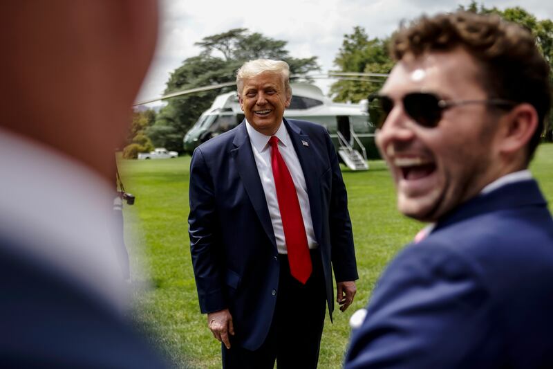 President Donald Trump jokes with supporters as he departs the White House for a trip to Ohio on August 6, 2020.