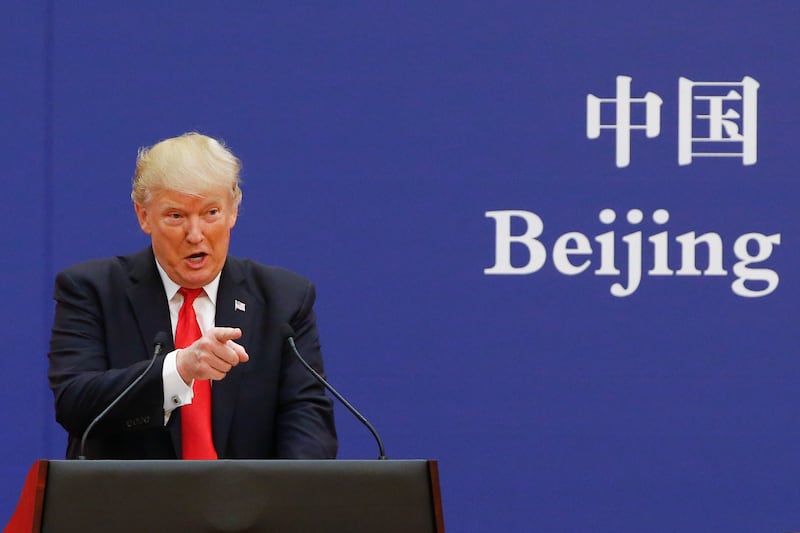President Donald Trump points as he speak to business leaders at the Great Hall of the People on November 9, 2017 in Beijing, China.