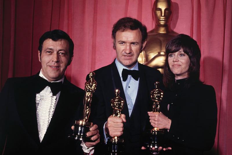 Philip D’Antoni, left, Gene Hackman, center, and Jane Fonda, right, holding their 1972 Academy Awards. D’Antoni produced “best picture” winner “The French Connection,” which Hackman starred in.