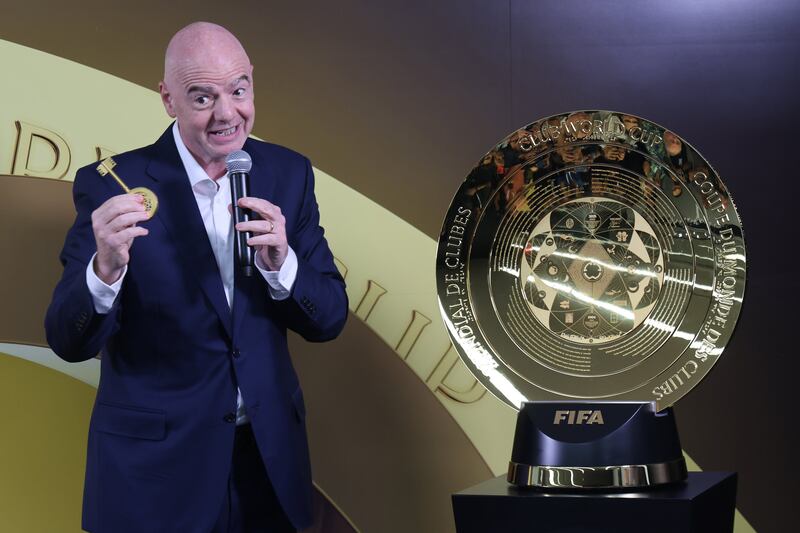 FIFA president Gianni Infantino shows off the key to the FIFA Club World Cup trophy after unveiling it in a May press event.