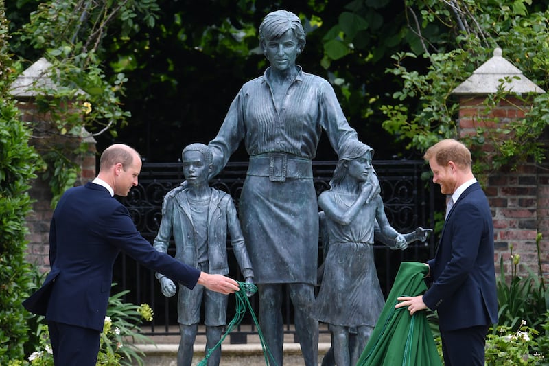 Prince William, Duke of Cambridge (left) and Prince Harry, Duke of Sussex unveil a statue they commissioned of their mother Diana, Princess of Wales, in the Sunken Garden at Kensington Palace, on what would have been her 60th birthday on July 1, 2021 in London, England.
