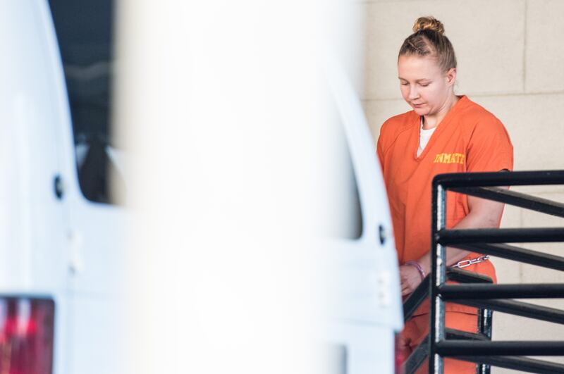 Wearing an orange prison jumpsuit, Reality Winner exits a courthouse in Augusta, Georgia on June 8, 2017.