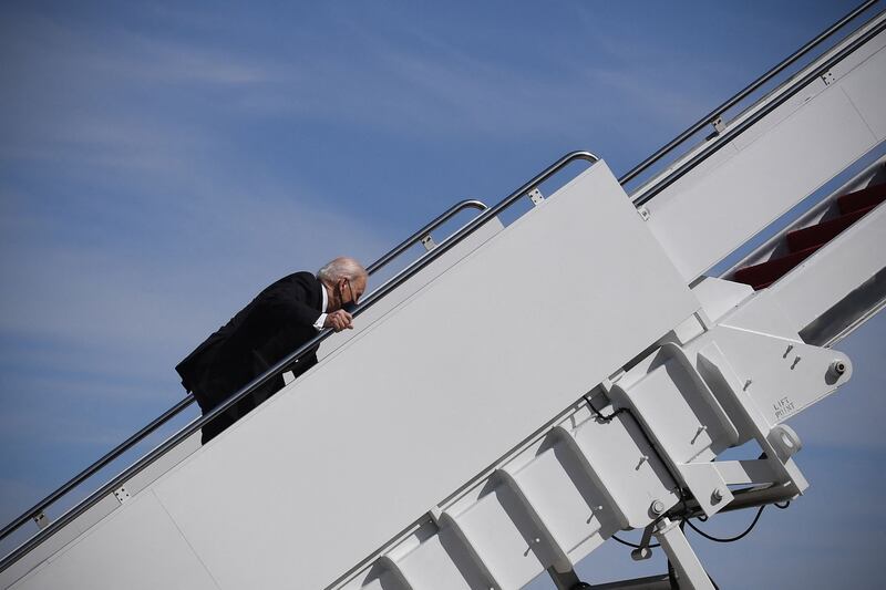 US President Joe Biden trips while boarding Air Force One at Joint Base Andrews in Maryland on March 19, 2021. President Biden travels to Atlanta, Georgia, to tour the Centers for Disease Control and Prevention, and to meet with Georgia Asian American leaders, following the Atlanta Spa shootings. (Photo by Eric BARADAT / AFP) (Photo by ERIC BARADAT/AFP via Getty Images)