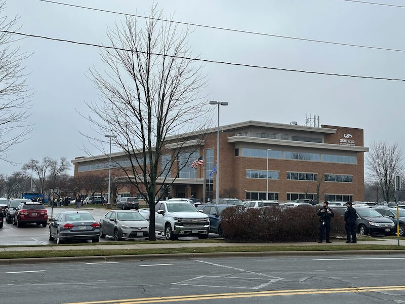 Emergency vehicles are parked outside of the SSM Health clinic where parents are being reunified with children after a shooting at the Abundant Life Christian School in Madison, Wis., Monday, Dec. 16, 2024. (AP Photo/Scott Bauer)