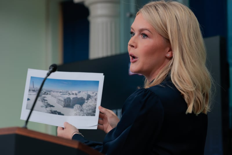 White House Press Secretary Karoline Leavitt holds up a picture during her briefing on July 31, 2025 as she announced President Donald Trump wants to build a new ballroom on White House grounds.