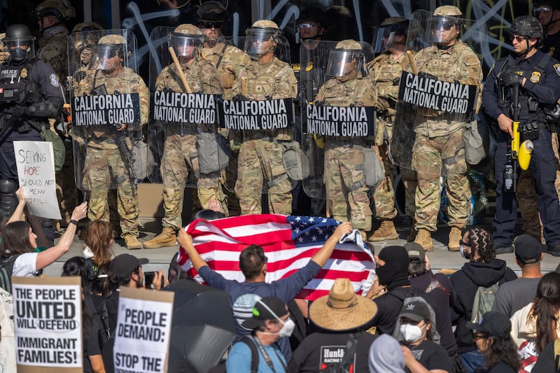 Protesters confront California National Guard soldiers and police outside of a federal building as protests continue in Los Angeles.