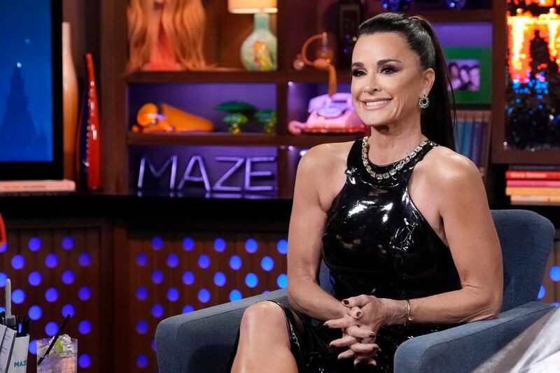 Image: Kyle Richards in black patent halter dress