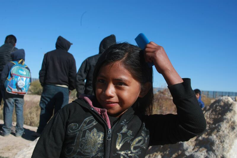 Migrant children from Guatemala crossed the river with their parents to reach the United States in Jerez city, Chihuahua, Mexico, on 19 December 2018.
