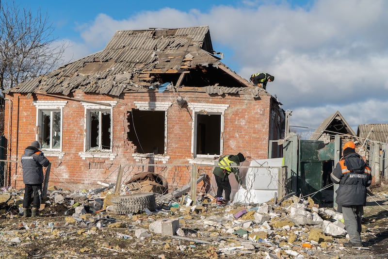 A house in Zolochiv stands in ruins with residents work to repair its damage.