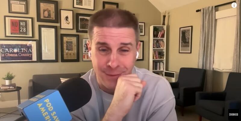 Pod Save America host Dan Pfeiffer speaks into a microphone.