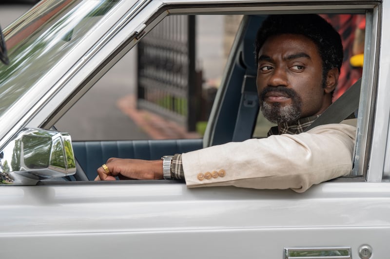 Jelani Alladin sits in a car in a still from ‘Fellow Travelers’