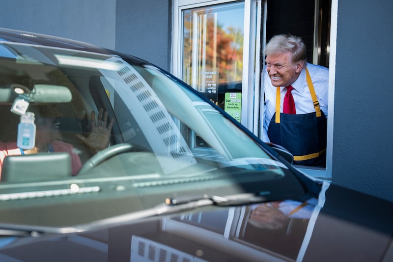 President Donald Trump hands out food while standing at a drive-thru window during a campaign stop at a McDonald's in Feasterville-Trevose, PA on Sunday, Oct. 20, 2024.