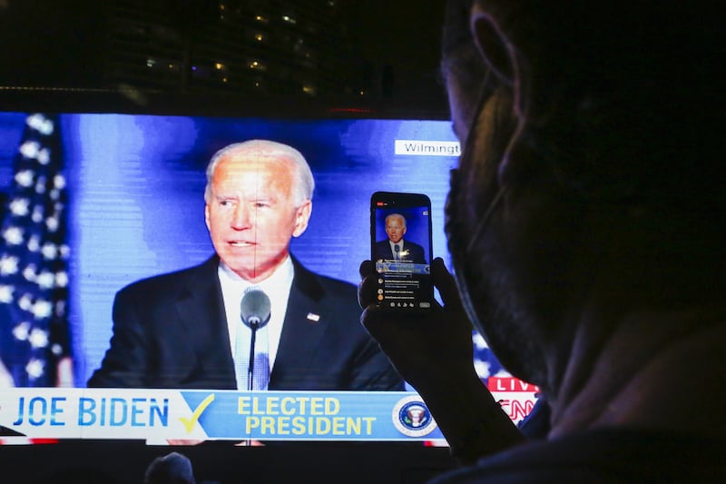 FLORIDA, USA - NOVEMBER 7: A supporter of the Democratic party uses his phone during Joe Biden's speech as 46th U.S President in Miami, Florida, United States on November 7, 2020. (Photo by Eva Marie Uzcategui Trinkl/Anadolu Agency via Getty Images)