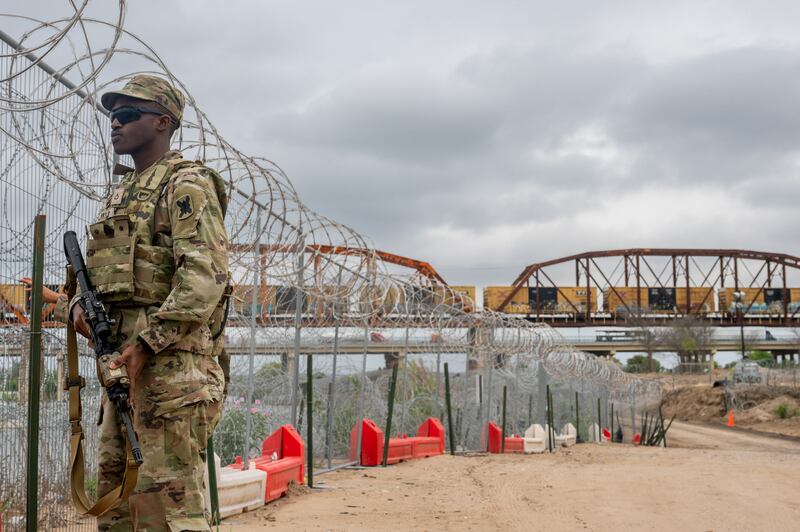 A Texas National Guard soldier patrols near the Rio Grande river at Shelby Park in Eagle Pass, Texas.