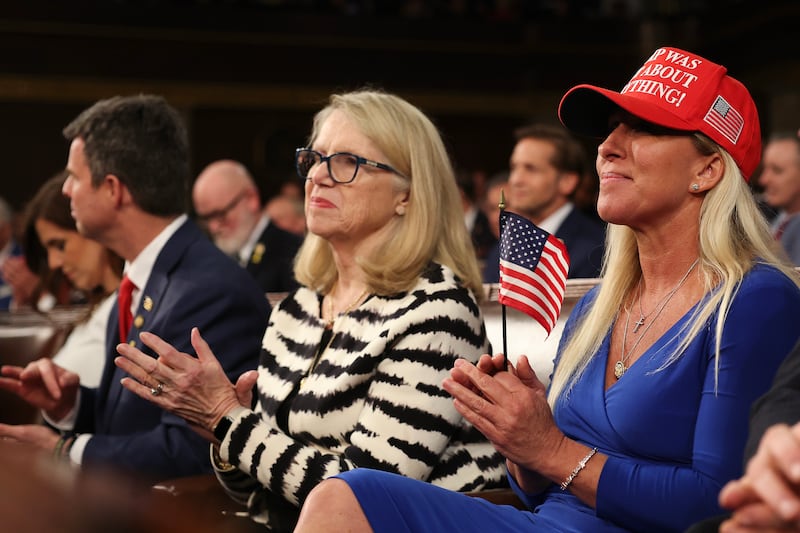 (L-R) Rep. John McGuire (R-VA), Rep. Carol Miller (R-WV), and Rep. Marjorie Taylor Greene (R-GA) attend U.S. President Donald Trump's address to a joint session of Congress at the U.S. Capitol on March 04, 2025 in Washington, DC.