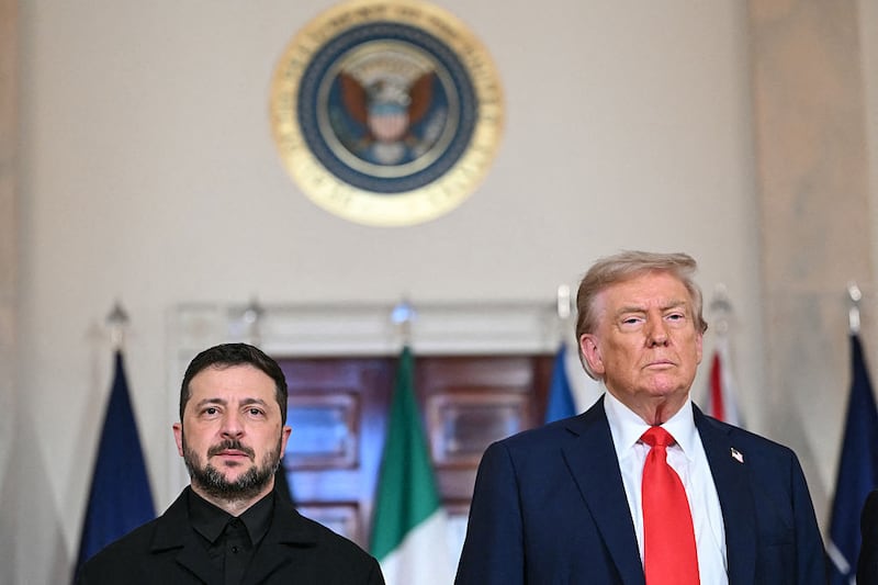 US President Donald Trump and Ukrainian President Volodymyr Zelensky stand for a family photo with European leaders in the Cross Hall of the White House in Washington, DC, on August 18, 2025. European leaders join Ukrainian President Volodymyr Zelensky in talks with US President Donald Trump on August 18, as they try to find a way to end Russia's offensive. The leaders heading to Washington on Monday to appear alongside Zelensky call themselves the "coalition of the willing." (Photo by ANDREW CABALLERO-REYNOLDS / AFP) (Photo by ANDREW CABALLERO-REYNOLDS/AFP via Getty Images)