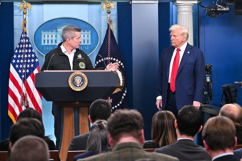 US President Donald Trump (R) looks on as Transportation Secretary Sean Duffy (L) speaks about the mid-air crash between American Airlines flight 5342 and a military helicopter in Washington, in the Brady Press Briefing Room at the White House on January 30, 2025 in Washington, DC. Divers pulled bodies from the icy waters of Washington's Potomac river Thursday after a US military helicopter collided midair with a passenger plane carrying 64 people, with officials saying there were likely no survivors. (Photo by ROBERTO SCHMIDT / AFP) (Photo by ROBERTO SCHMIDT/AFP via Getty Images)