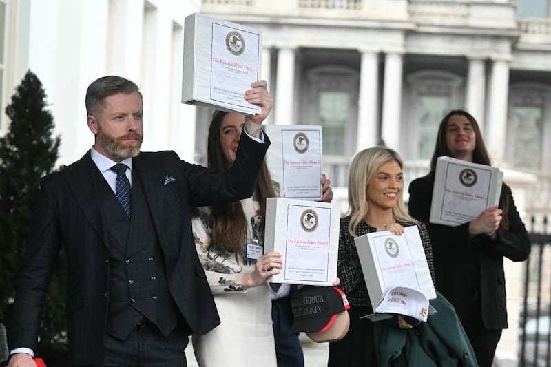 Political commentator Rogan O'Handley, aka DC Draino, TikToker Chaya Raichik, commentator Liz Wheeler and conservative activist Scott Presler carry binders bearing the seal of the US Justice Department reading "The Epstein Files: Phase 1" as they walk out of the White House in Washington, D.C. on February 27, 2025.