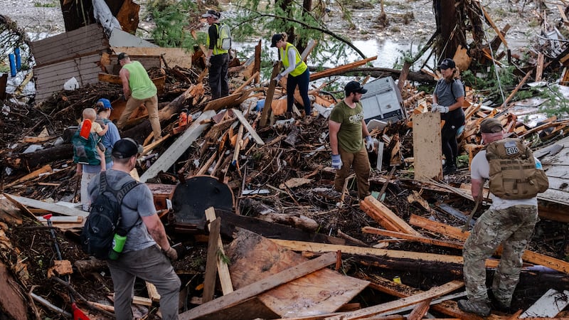 Search and rescue workers dig through debris looking for any survivors or remains of people swept up in the flash flooding on July 6, 2025 in Hunt, Texas. Heavy rainfall caused flooding along the Guadalupe River in central Texas with multiple fatalities reported.