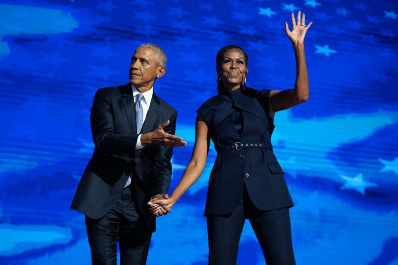 Former President Barack Obama and former first lady Michelle Obama appear on stage in between their addresses on the second night of the Democratic National Convention at the United Center in Chicago, Ill., on Tuesday, August 20, 2024.