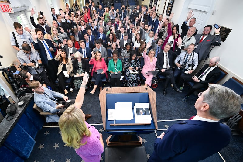 Reporters in the White House press briefing raise their hands to ask questions as White House Press Secretary Karoline Leavitt decried the press coverage of President Trump's first 100 days on Tuesday April 29, 2025.