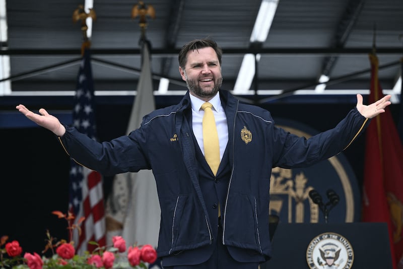 US Vice President JD Vance receives a Navy jacket as a gift after delivering the commencement address at the 2025 US Naval Academy graduation in Annapolis, Maryland, on May 23, 2025